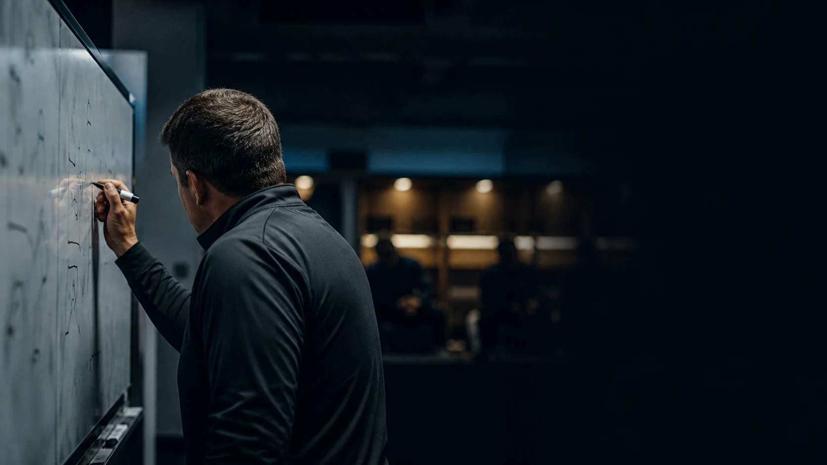 An anonymous coach revising the plan in a quiet locker room at halftime
